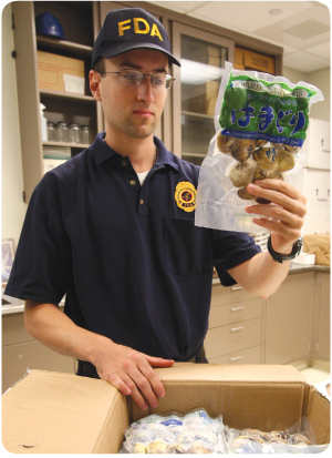 A package of clams is inspected by an FDA employee.