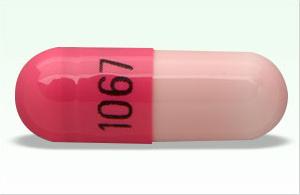 Pill 1067 Pink Capsule/Oblong is Clomipramine Hydrochloride