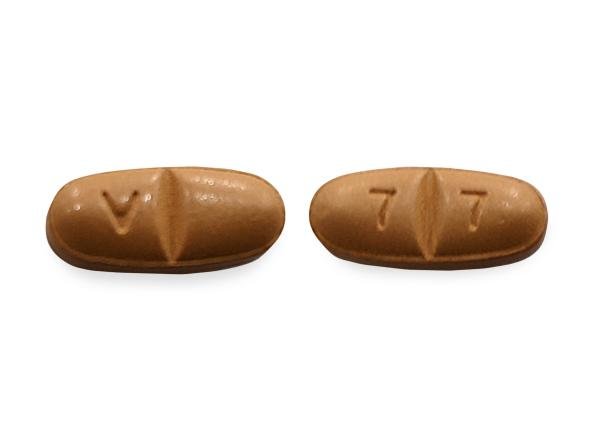 Pill V 7 7 Brown Oval is Oxcarbazepine