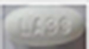 Pill LA38 White Oval is Atorvastatin Calcium