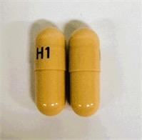 Pill H1 Beige Capsule/Oblong is Doxycycline (Anhydrous) Immediate/Delayed Release