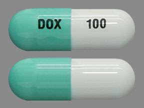 Pill DOX 100 Green & White Capsule-shape is Doxepin Hydrochloride
