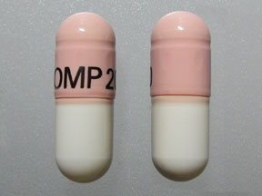 Pill OMP 20 Pink & White Capsule/Oblong is Omeprazole Magnesium Delayed-Release