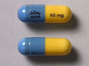 Pill Lilly 3239 60 mg Blue & Yellow Capsule/Oblong is Atomoxetine Hydrochloride