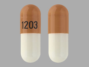 Pill 1203 Brown & White Capsule/Oblong is Trientine Hydrochloride