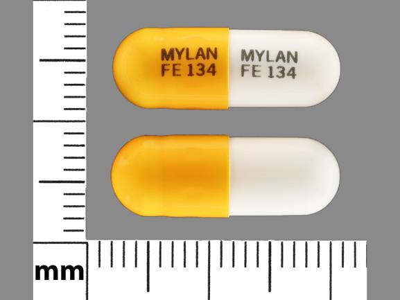 Pill MYLAN FE 134 MYLAN FE 134 Orange & White Capsule/Oblong is Fenofibrate (Micronized)