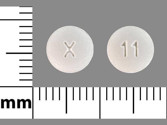Pill X 11 White Round is Donepezil Hydrochloride
