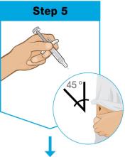 A close-up of a hand holding a syringe

Description automatically generated